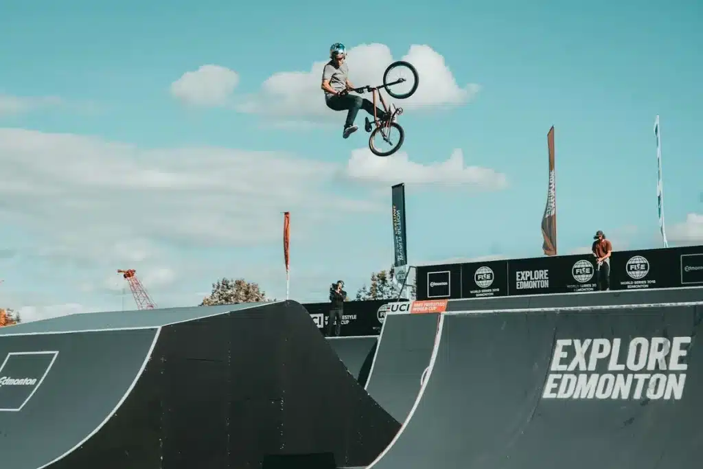 Ciclista de BMX faz acrobacia aérea durante competição em pista profissional